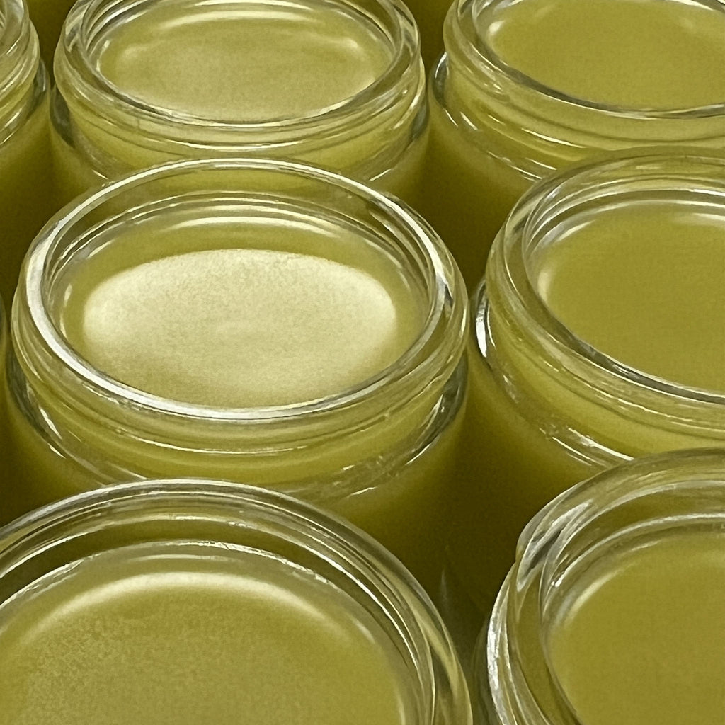 Multiple open jars of Skin Healer Salve