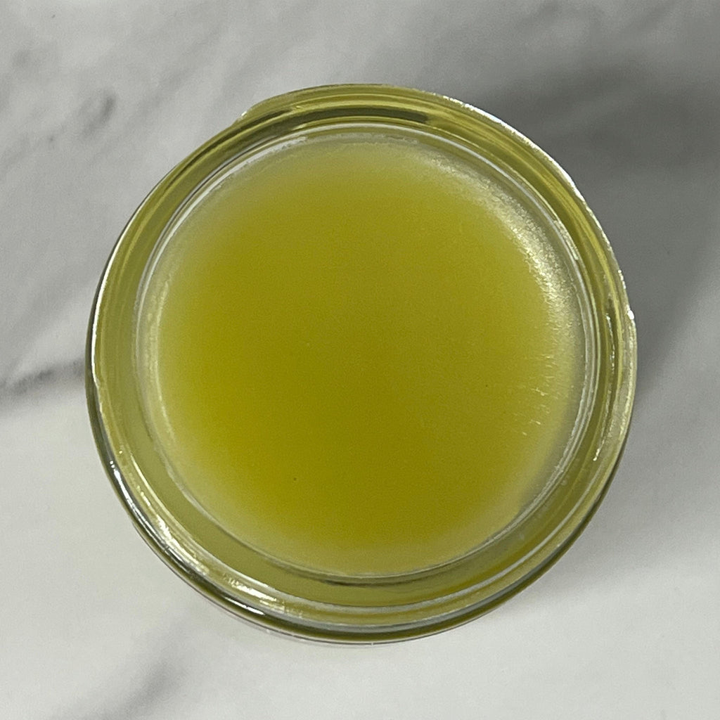 Direct top view of open jar of Belly & Vaginal Balm